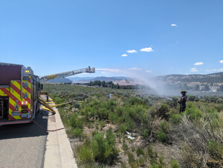 fire fighters spraying water on a field
