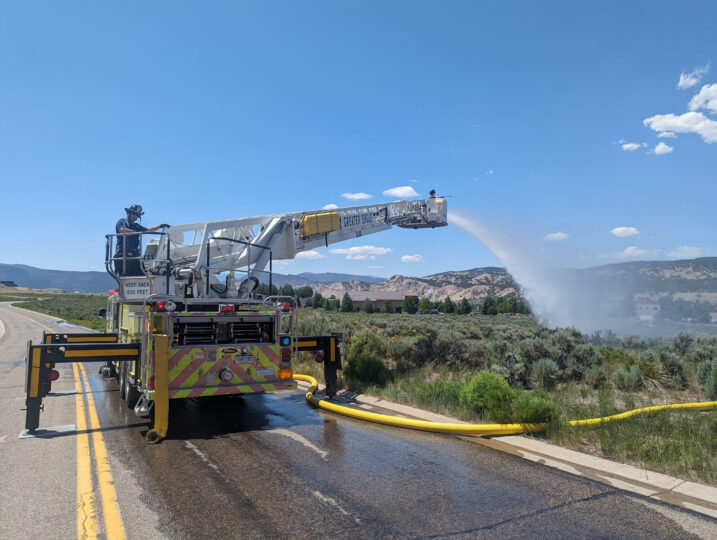 hose and ladder truck spraying water